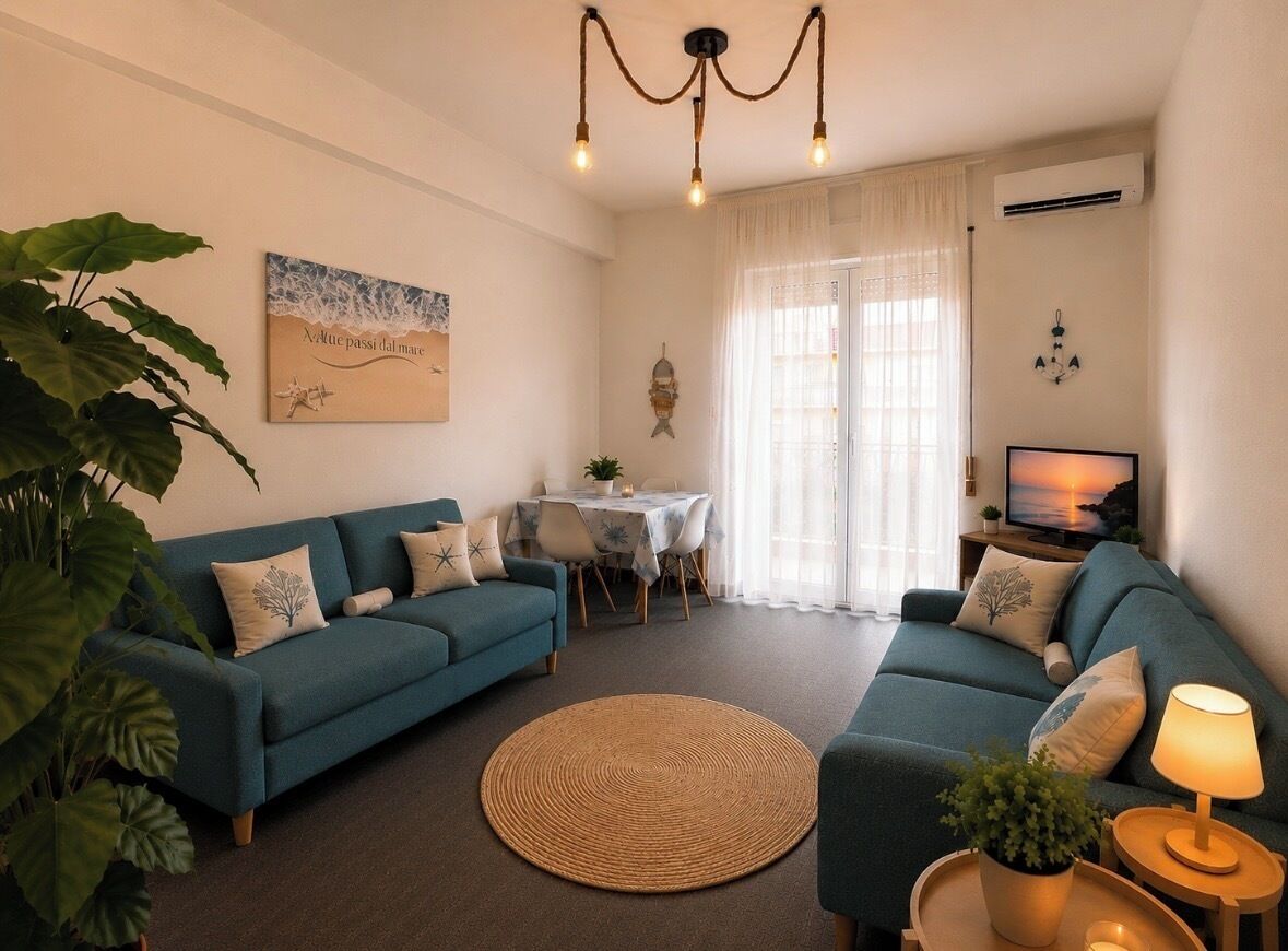 A living room with two sofas, a coffee table, a TV, and a dining area with a table and chairs.