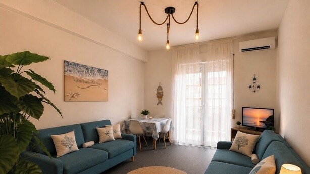 A living room with two sofas, a coffee table, a TV, and a dining area with a table and chairs. - Just a stone's throw from the sea (Torvaianica)
