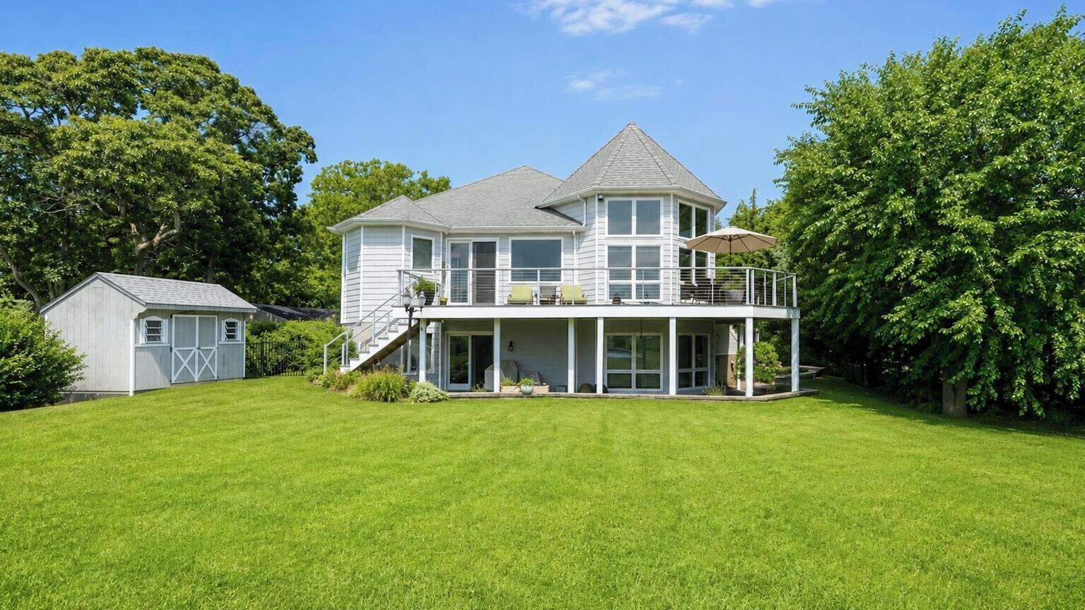 A two-story house with a covered porch and a separate garage.