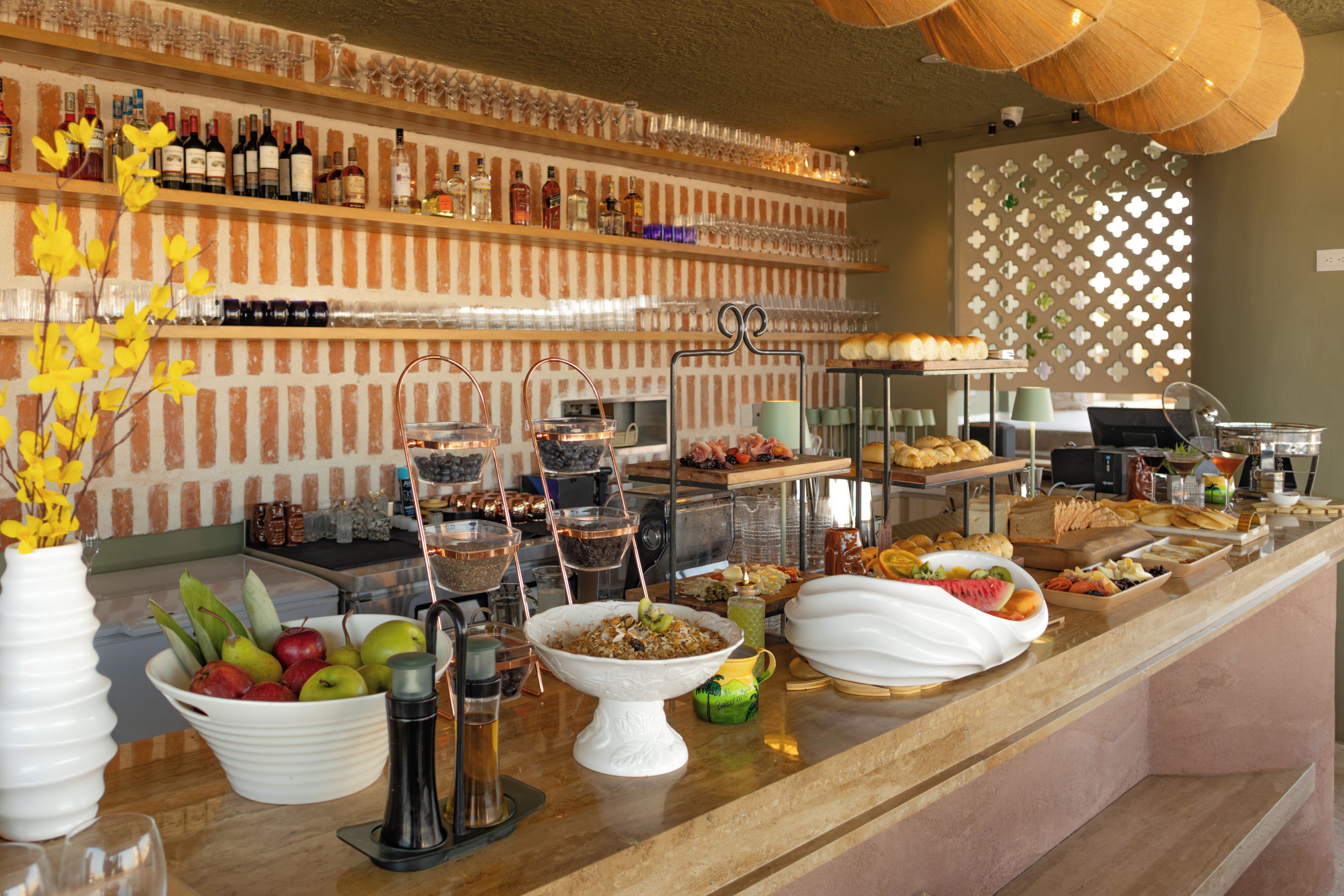 A buffet with various food items and a selection of beverages.