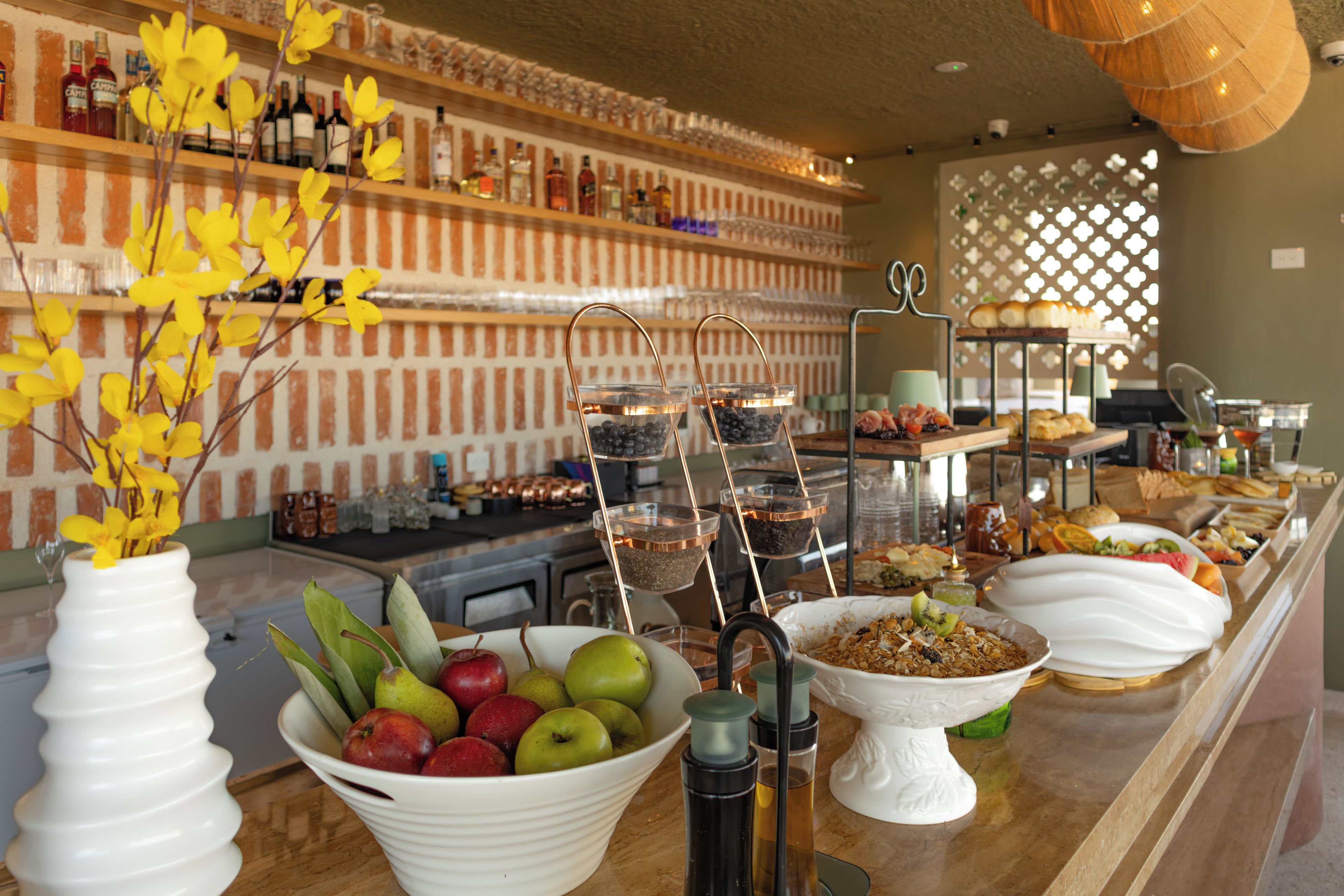 A buffet setup with various food items and a selection of beverages.