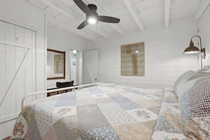 A bedroom with a bed, a ceiling fan, a wall-mounted lamp, and a large window. - Peace of Aska - Hot Tub (Blue Ridge)