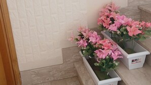 Uma escadaria com três jardineiras de flores brancas nos degraus.