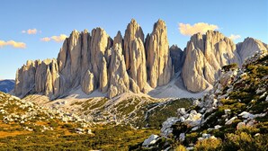 A mountainous landscape with rocky formations and sparse vegetation.