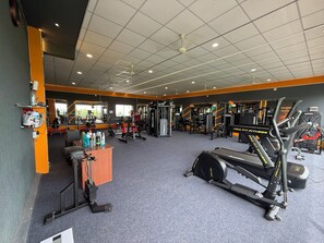 A gym with various exercise equipment, including treadmills and weight machines.