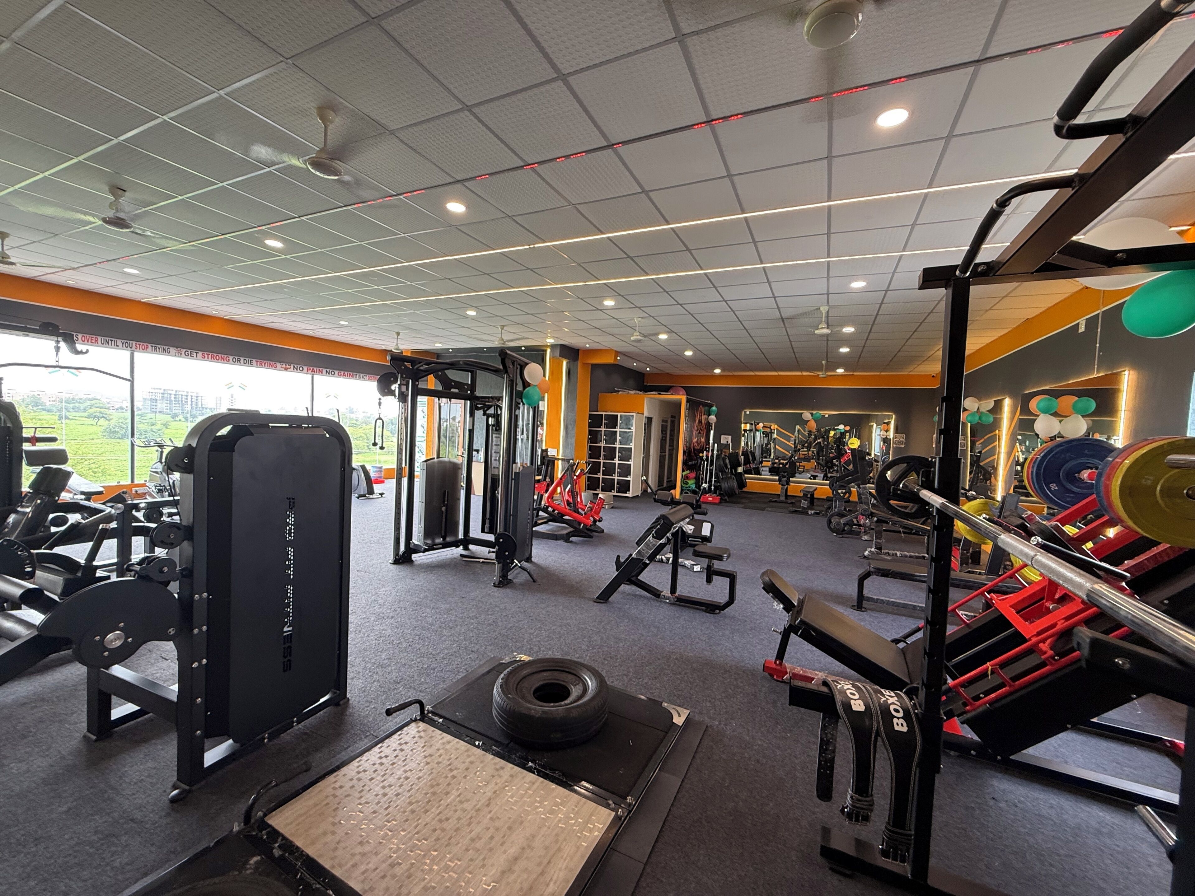 A gym with various exercise equipment, including weight machines, treadmills, and free weights.