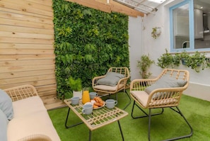 A cozy outdoor seating area with wicker chairs and a table set for breakfast. - El Rincón De La Alhambra, by DaiMar, with parking (España)