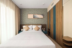 A hotel room with a large bed, a headboard with a painting, a nightstand, and a wardrobe. - Deluxe Escape  Luxury Wellness Hotel (Jumeirah Village Triangle)