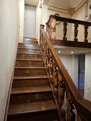 A wooden staircase with a handrail leading to an upper floor. - PONTEVECCHIO, featuring original 17th-century furnishings and frescoes (Firenze)