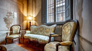 A room with a vintage sofa, two armchairs, and a floor lamp. - PONTEVECCHIO, featuring original 17th-century furnishings and frescoes (Firenze)