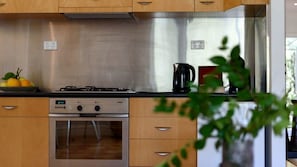 A kitchen with a Bosch oven, a gas stove, and a coffee maker. - Amazing Vacation Rental with Lake Views in Daylesford, Victoria (Daylesford)