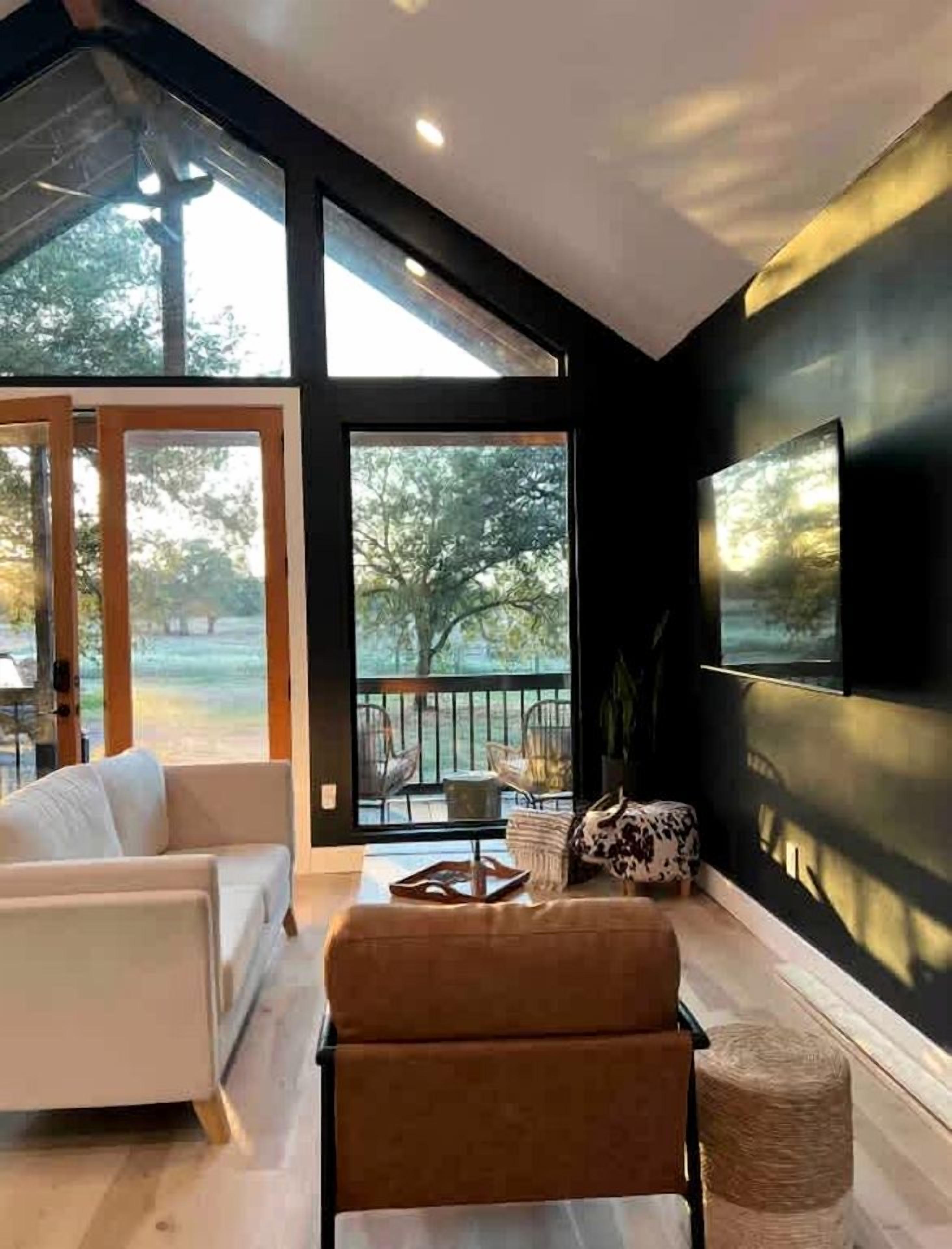 A modern living room with a sofa, a coffee table, and a TV mounted on the wall.