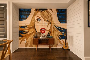 A room with a mural, a wooden desk, and a guitar. - NEW! Nashville Era Nights & Rooftop Dreams (Nashville)