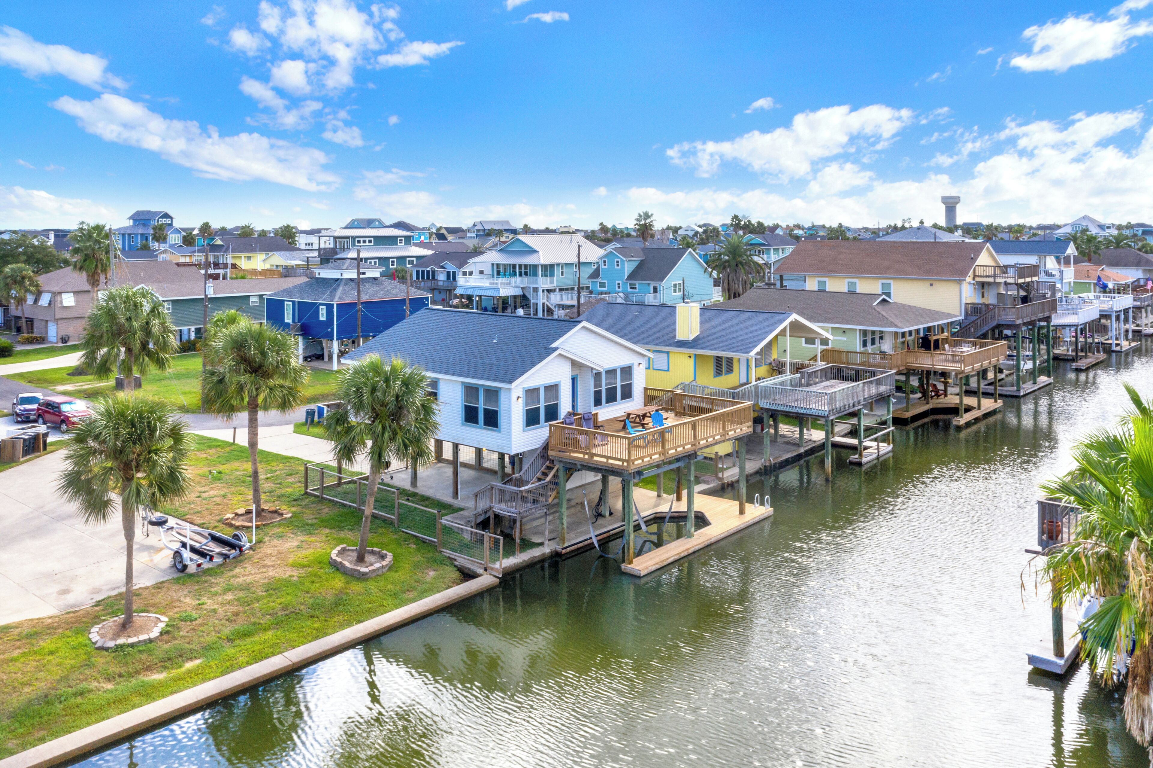 A waterfront residential area with houses connected by docks and a canal.