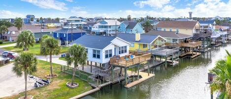 A waterfront residential area with houses connected by docks and a canal.