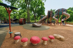 A playground with a slide, climbing structures, and a circular seating area. - The Park House, 1.8mi to Square, VelvetDitchVillas (Oxford)