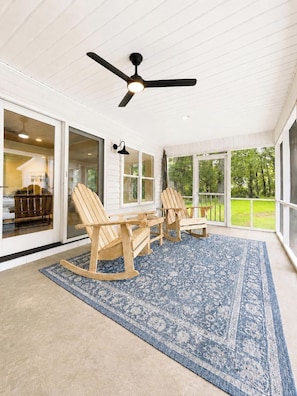 A covered patio with a ceiling fan, wooden chairs, a table, and a patterned rug. - The Park House, 1.8mi to Square, VelvetDitchVillas (Oxford)