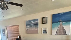 A living room with a sectional sofa, a coffee table, and a ceiling fan. - Pet-Friendly Riverfront Getaway with Outdoor Entertaining & Bonus Camper in Cascade, Idaho (Cascade)