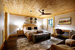 A bedroom with a wooden ceiling, a bed with a headboard, a desk, and a chair. - Enchanting Creekside Mountain Cabin Retreat with Luxury Amenities in the Heart of Scenic Blue Ridge, Georgia (Blue Ridge)