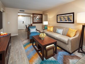 A living room with a sofa, coffee table, and a TV stand. - Family-Friendly 2 Bedroom Villa at Kaua'i Resort (Koloa)