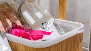 A storage bin with various items, including a white hat and a pink ribbon.