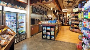 A grocery store interior with refrigerated sections, a bakery display, and shelves stocked with various products. - Princeville One Bedroom Villa Resort w/ Amenities (Princeville)
