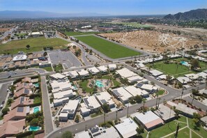 A residential area with multiple-story buildings, roads, and green spaces. - Chic Indian Wells Pool, 4 BD-Next to Tennis Garden (Indian Wells)