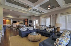 A spacious living area with sofas, a coffee table, and a dining area with chairs and a table. - Millville by the Sea- shuttle access Bethany beach (Millville)