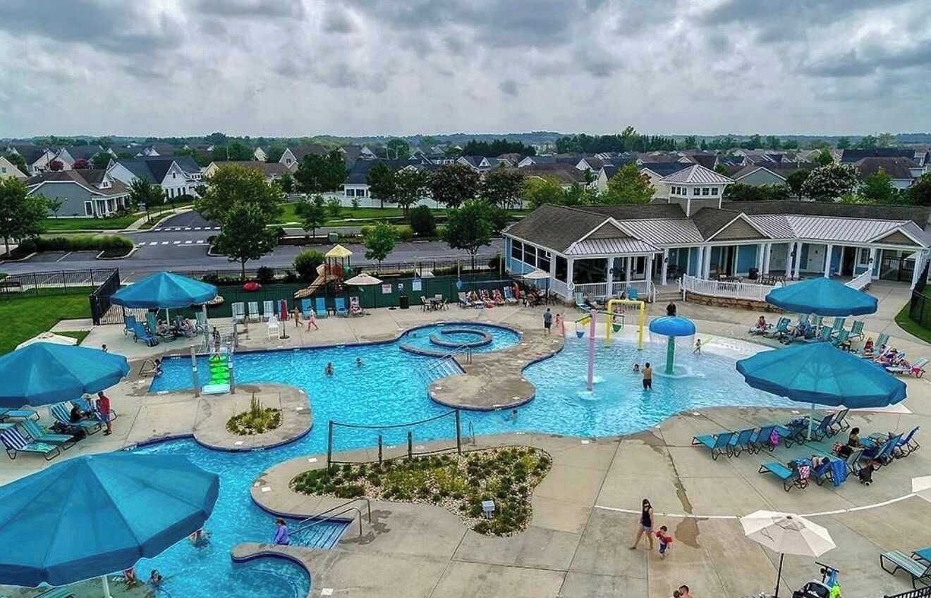 A swimming pool area with multiple pools and lounge chairs.