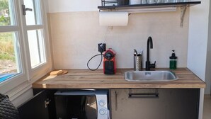 A compact kitchen with a built-in microwave, a sink, and a compact stove. - Seaview Apartment Galissas, Blue Lagoon Complex A9 (Galissas)