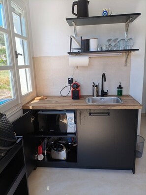 A compact kitchen with a built-in microwave, a sink, and a compact stove. - Seaview Apartment Galissas, Blue Lagoon Complex A9 (Galissas)