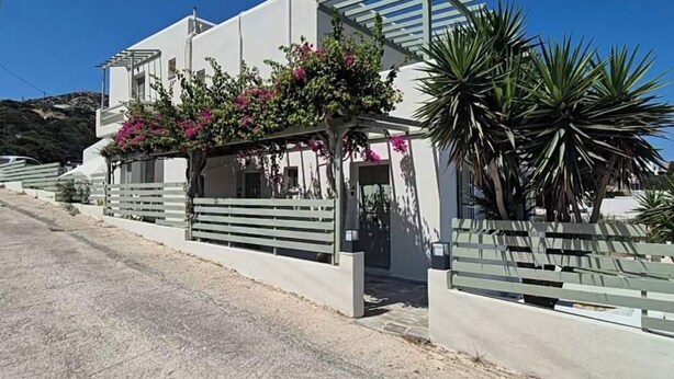 A modern two-story house with a white exterior, a covered porch with pink flowers, and a concrete driveway. - Seaview Apartment Galissas, Blue Lagoon Complex A9 (Galissas)