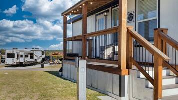 A two-story RV park with wooden decks and a covered picnic area.