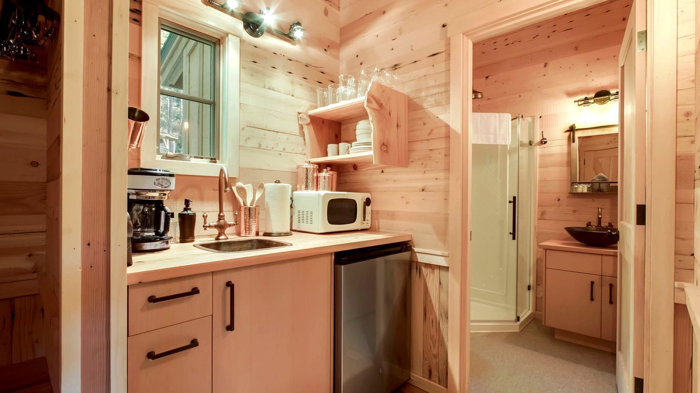 Coffee/tea maker, fridge, microwave, dining table