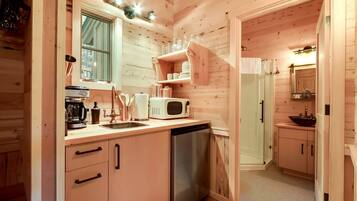 Coffee/tea maker, fridge, microwave, dining table