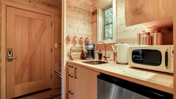 Coffee/tea maker, fridge, microwave, dining table