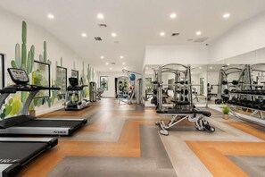A gym with treadmills, weight machines, and exercise balls. - Stylish Suites: Pet-Friendly 2BR in Tempe | Near ASU w/ Pools & Gym (Tempe)