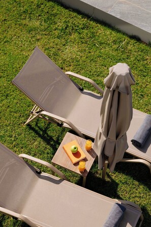 Two lounge chairs with an umbrella, a small table, and a book. -     Lamon Villa | Elegant Seaside Escape with Private Pool (Myrthianos Plakias)