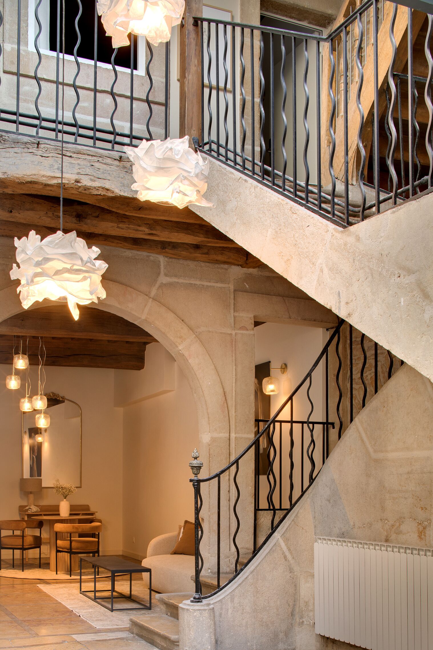 A staircase with a wrought iron railing leading to a balcony.