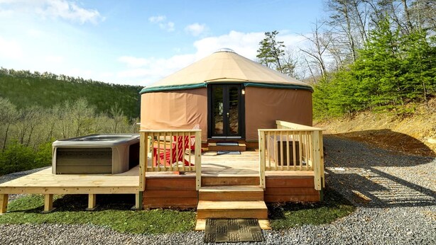 A yurt with a covered entrance, a small porch, and a bench. - Fantastic Yurt with Hot-tub and Fire Pit in Wardensville, West Virginia (Wardensville)