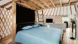 A bedroom with a bed, a TV, a desk, and a ladder. - Fantastic Yurt with Hot-tub and Fire Pit in Wardensville, West Virginia (Wardensville)