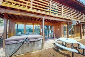 A wooden cabin with a covered patio, a hot tub, and a picnic table. - The Mountain Artist's Retreat - Secluded Mtn Home • Hot Tub & Big Deck (Florissant)
