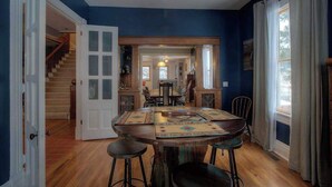 A dining area with a round table, chairs, and a decorative centerpiece.