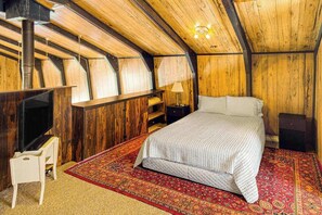 A bedroom with a bed, a television, a lamp, and a wooden ceiling. - Rainbows End - Mountain-View Home • Basketball Court (Cripple Creek)