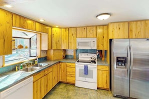 A kitchen with wooden cabinets, a stainless steel refrigerator, a microwave, and a dishwasher. - Rainbows End - Mountain-View Home • Basketball Court (Cripple Creek)
