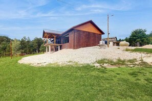 A modern building with a sloped roof, a covered outdoor area, and a gravel driveway. - Bear Butte Retreat - Private Hot Tub Retreat • Secluded (Deadwood)