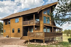 A multi-story wooden building with balconies, large windows, and a sloped roof. - Skyline Ridge - Secluded Retreat • Stunning Views & Loft (Florissant)