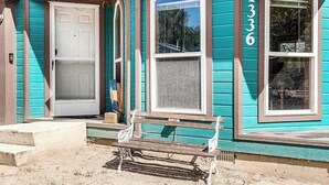 A house with a front door, a bench, and a window with the number 1336. - Rocky Mountain Rustic - Mountain-View Home • AC & Fast WiFi (Colorado Springs)