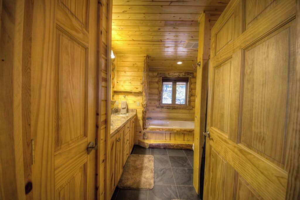 A wooden interior with a staircase leading to a window.