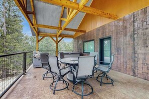 An outdoor patio with a wooden pergola, a grill, and outdoor seating. - Bear Butte Hideaway - Secluded Hideaway w/ Private Hot Tub (Deadwood)